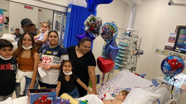 Akel in hospital with his parents and siblings. The family moved to Ipswich from Eidsvold to be close to the Queensland Children’s Hospital.