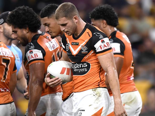 Wests Tigers players show their frustration after a Broncos try.