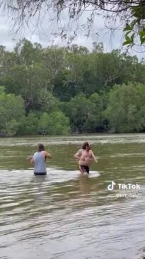 Two men wading in croc-infested Jardine River