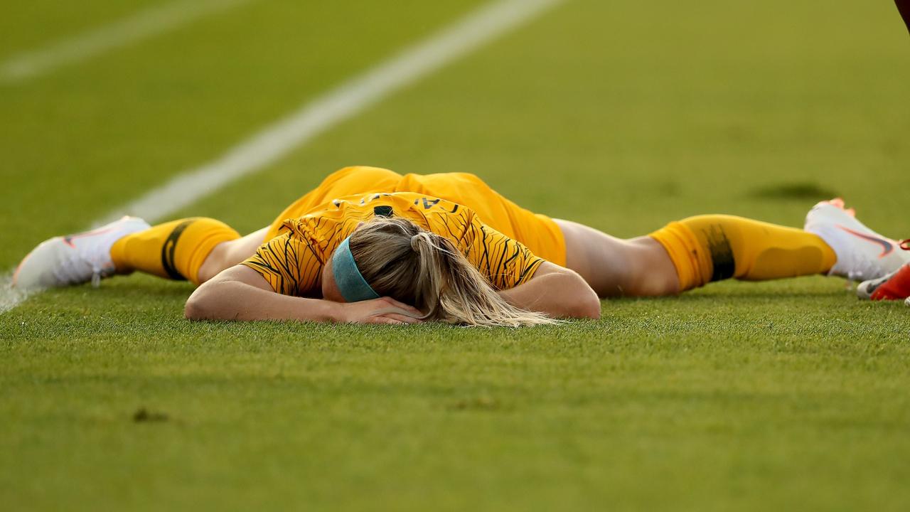 Ellie Carpenter of Australia lies on the ground after a nasty blow to the face.