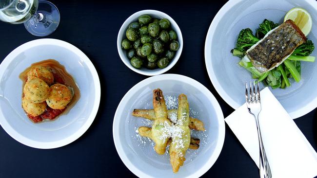 From left: arancini balls, sauteed olives, zucchini flowers and barramundi.