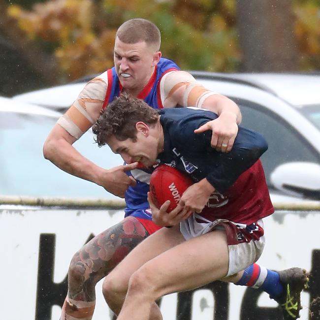 Gisborne’s Jack Scanlon wraps Sandhurst’s Lachlan Wright up in a tackle.