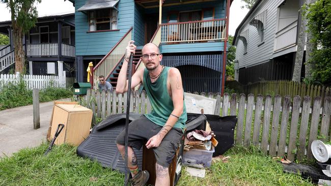 Martin Wright (front) and Will Orrick, with the ruined furniture some from two weeks ago and from yesterday, cleaning up there house at 85 Longlands St Gabba, Flooding Clean Up, Gabba - on Sunday 15th December 2024 - Photo Steve Pohlner