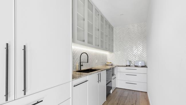 The feature marble benchtop even makes an appearance in the walk-in pantry.