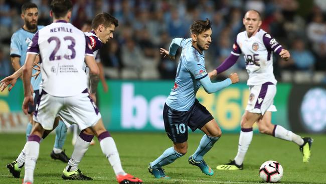 Sydney FC’s Milos Ninkovic looks to weave his way past Perth Glory players at the SCG on Thursday night. Picture: Getty Images
