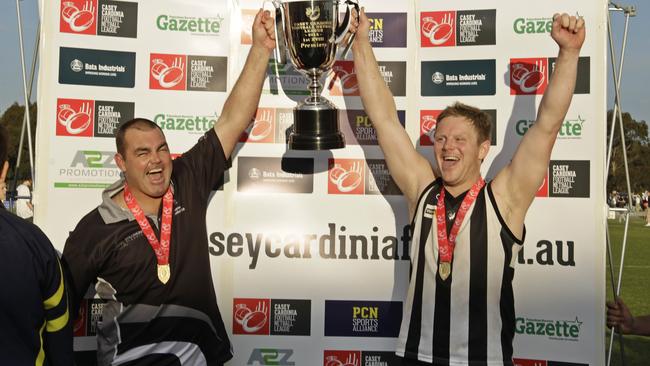 Coach Chris Toner and captain Michael Collins hoist the silverware after Narre Warren’s 2013 triumph. Picture: Valeriu Campan