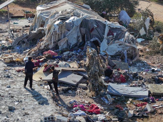 People inspecting the damage after a reported air strike on a makeshift camp for displaced Syrians near the town of Maarrat Misrin in the northern part of the Idlib. Picture: AFP