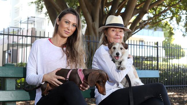 Jacqueline Parish with Tilly and Kathryn Downey with Archie hope their presence will inspire the community to return to the park after multiple dogs were poisoned. Picture: AAP/Richard Gosling