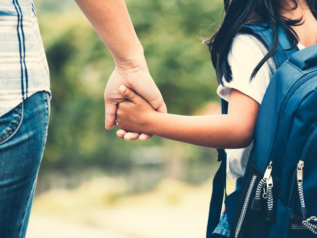 Back to school. Generic photo of child walking with mother from Istock