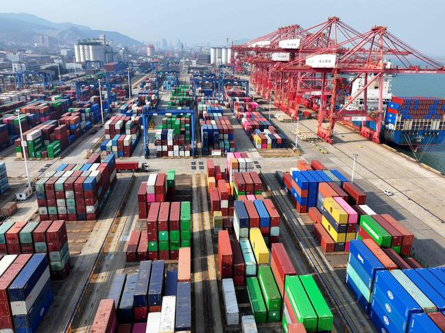 A container ship is loaded at the port in Lianyungang, in China's eastern Jiangsu province on December 10, 2024. Chinese President Xi Jinping warned on December 10 that there would be "no winners" in a trade war with the United States and vowed the country would hit its growth goals for the year. (Photo by AFP) / China OUT