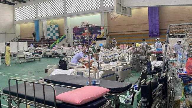 Patients are attended to in a makeshift medical treatment area in the recreational hall of a hospital in Bangkok on Saturday, a day after an earthquake struck central Myanmar and Thailand. Picture: Montira Rungjirajittranon / AFP