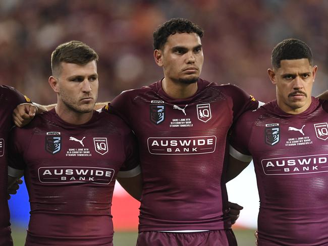 TOWNSVILLE, AUSTRALIA - JUNE 09:  Jai Arrow of the Maroons, Xavier Coates of the Maroons and Dane Gagai of the Maroons sing the national anthem before game one of the 2021 State of Origin series between the New South Wales Blues and the Queensland Maroons at Queensland Country Bank Stadium on June 09, 2021 in Townsville, Australia. (Photo by Ian Hitchcock/Getty Images)