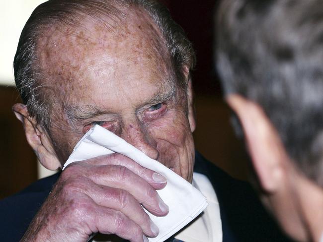 Britain's Prince Philip, the Duke of Edinburgh, wipes his face at an engagement just hours after he announced he would retire from public life. Picture: John Stillwell/Pool Photo via AP.