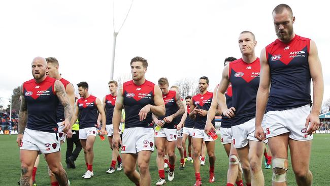 Demons players walk from the field dejected. (Photo by Matt King/Getty Images)