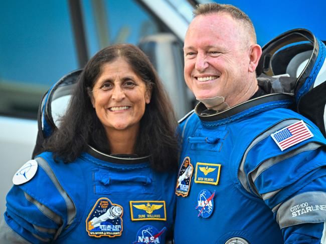 (FILES) NASA astronauts Butch Wilmore (R) and Suni Williams, wearing Boeing spacesuits, depart the Neil A. Armstrong Operations and Checkout Building at Kennedy Space Center for Launch Complex 41 at Cape Canaveral Space Force Station in Florida to board the Boeing CST-100 Starliner spacecraft for the Crew Flight Test launch , on June 5, 2024. Two astronauts stranded in space may sound like the start to a big-screen science thriller, but the Boeing Starliner mission is no work of Hollywood fiction. Astronauts Barry "Butch" Wilmore and Sunita "Suni" Williams were originally scheduled to spend a little more than a week aboard the International Space Station as part of the debut crew flight test of the Starliner. However, the spacecraft encountered several issues during the flight, and now the two astronauts will likely have to extend their stay aboard the ISS for several months. (Photo by Miguel J. Rodriguez Carrillo / AFP)