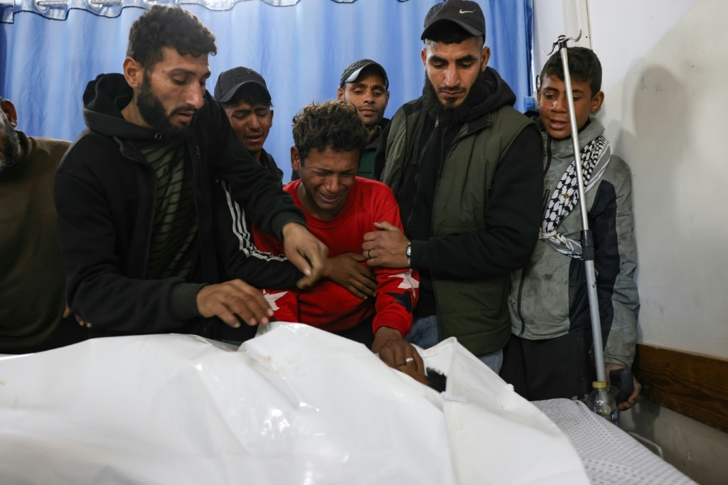 A young man in Beit Hanoun, central Gaza, bids farewell to one of two Palestinians killed -- Israel said an air strike had targeted suspects in northern Gaza