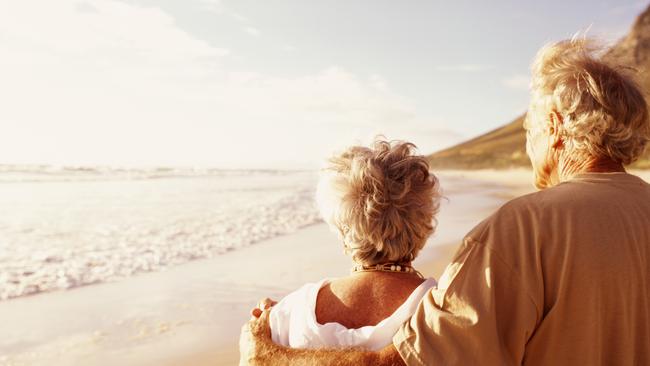 Senior couple embracing on beach, rear viewretirees thinkstockolder couple walking on the beachsuperannuation genericelderly, active, wealth, couple, aging, beach, cancer