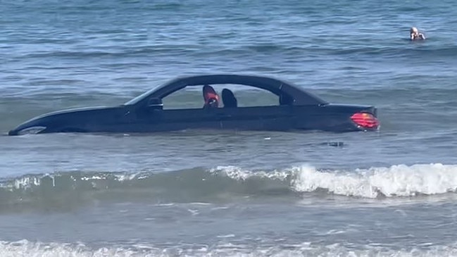 A BMW driver has amusingly been told he “can’t park there” after footage went viral of his car floating out to sea. Picture: Facebook