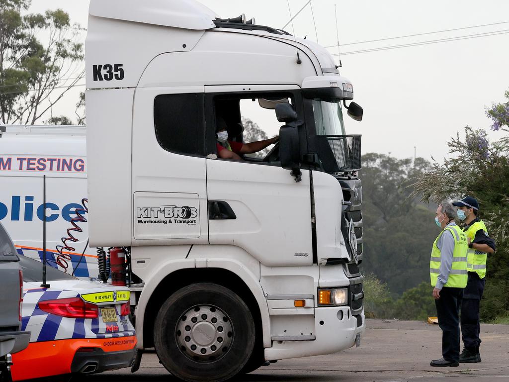 NSW Police inspect a truck at the Kit Bros depot. Picture: Toby Zerna