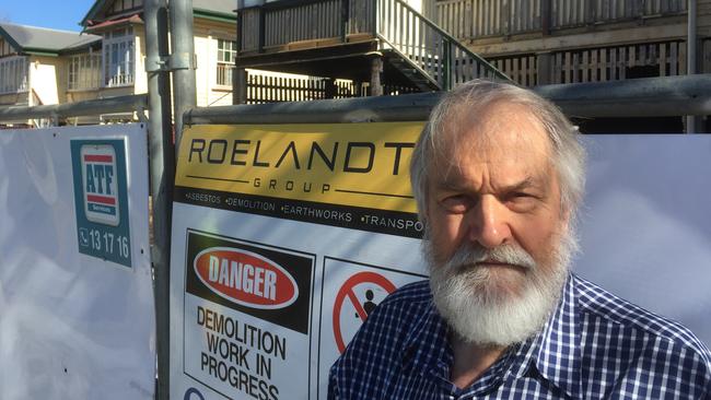 East Brisbane historian Geraint Gregory at two of the Lytton Rd homes ready for removal. Pictures: Brian Bennion