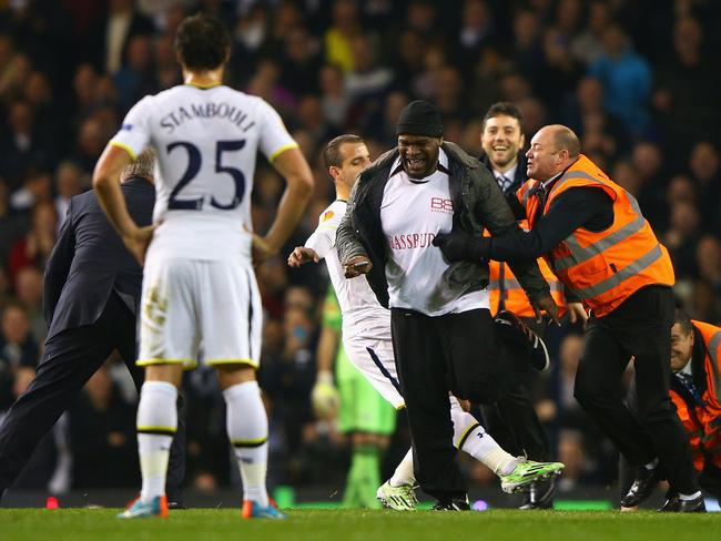 LONDON, ENGLAND - NOVEMBER 27: Roberto Soldado of Spurs attempts to tackle a pitch invader as stewards apprehend him during the UEFA Europa League group C match between Tottenham Hotspur FC and FK Partizan at White Hart Lane on November 27, 2014 in London, United Kingdom. (Photo by Ian Walton/Getty Images)