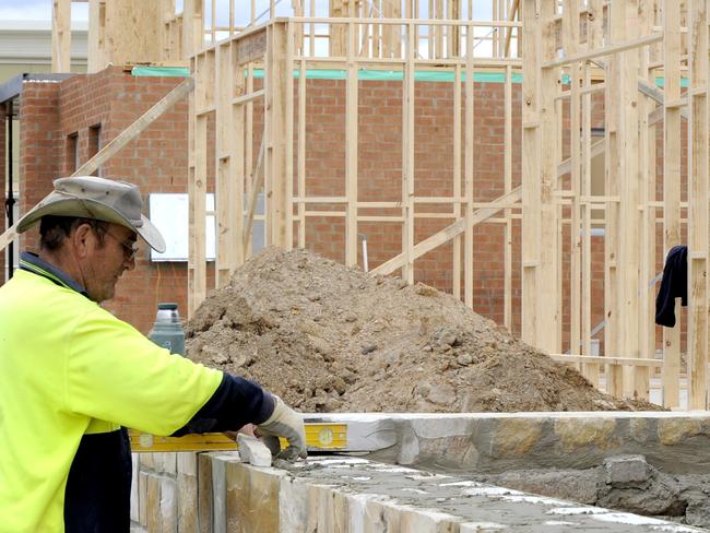 A stonemason at work on a new home in Canberra, Friday, April 24, 2009. The increase in the Federal government's First Home Owners Grant, which was raised from $7,000 to $14,000 for existing dwellings and from $14,000 to $21,000 for new homes as part of the government's $10.4 billion stimulus package last year, is due to expire on June 30. (AAP Image/Alan Porritt) NO ARCHIVING