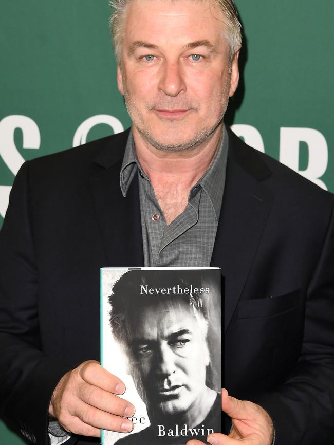 Alec Baldwin holds a copy of his new book Nevertheless: A Memoir. Picture: AFP