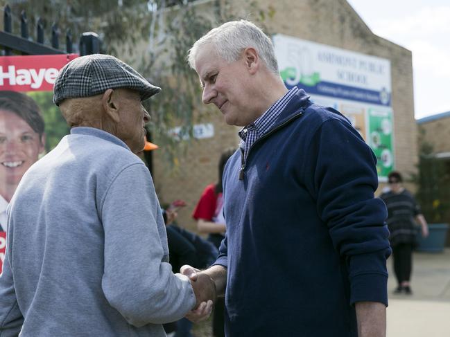 Mr McCormack greeting voters at Ashmont Public school. Picture: Dylan Robinson