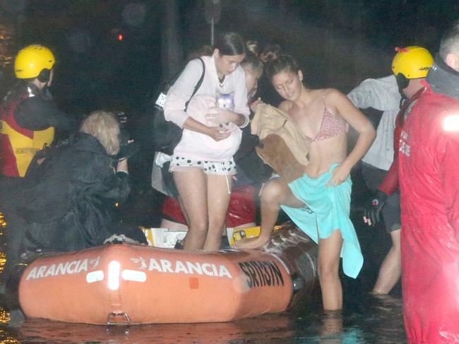 Carole Lloyd her grandson Dekota Davidson, Huana Cleaveland (holding cat pink shirt) Tia Grace (black top) and Malia Cleveland being evacuated by Surf Rescue from their home at 66 Mactier Street Narrabeen,  Narrabeen lagoon is flooding the area due to heavy rain. , Sydney. 9th February, 2020. Picture by Damian Shaw