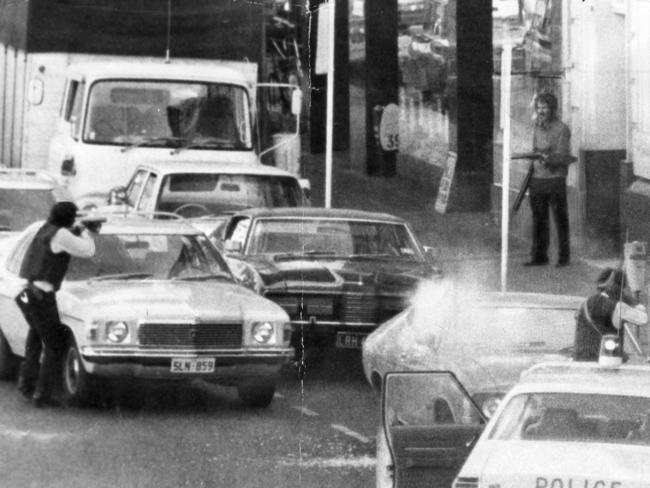 Hambly-Clark gun shop siege in Rundle Street, Adelaide, 11 May 1976. This pic of the dramatic scene in Rundle Street was taken by reader Mr J. A. Shaw, of Clarence Park, seconds before a police sniper fired on the gunman (Michael Leo O'Connor, pictured at right). The flare in the foreground is a tear gas canister bursting against a parked car.