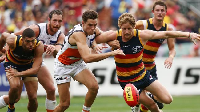 Pressure plus ... Rory Sloane battles the Giants’ Josh Kelly at Adelaide Oval. Picture: Morne de Klerk (Getty Images)