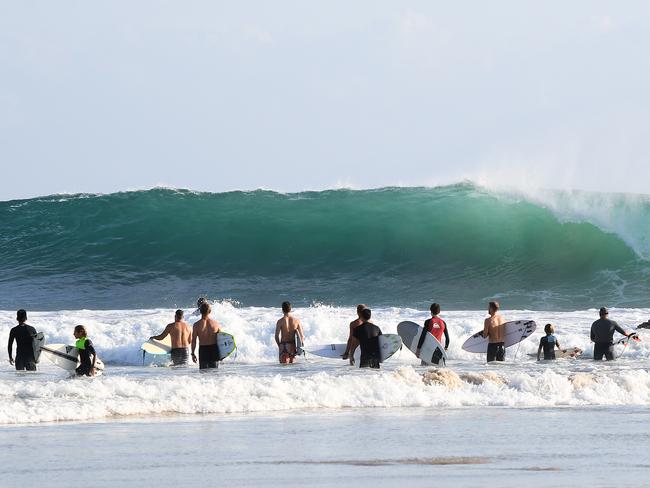 Surfers survey large surf before paddling out at Snapper Rocks on the Gold Coast, Sunday, February 18, 2018. The large swell is courtesy of Tropical Cyclone Gita, which devastated Tonga on Monday. (AAP Image/Dave Hunt) NO ARCHIVING