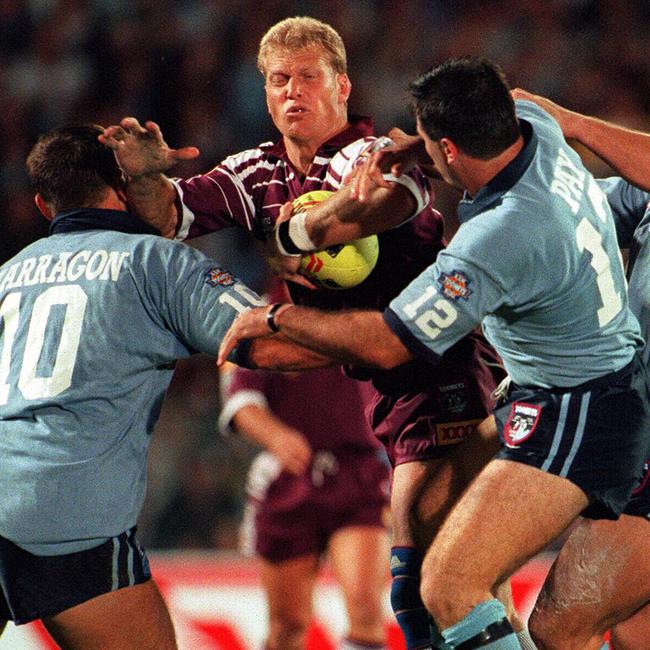 Gary Larson is tackled by Paul Harragon and Dean Pay in game one of the 1996 State of Origin series.