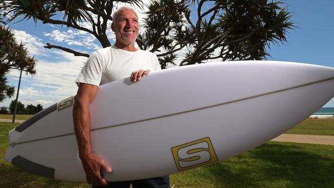 Quiksilver boss Greg Healy, with a surf board near the new Boardriders store containing all their brands , in Coolangatta, Gold Coast