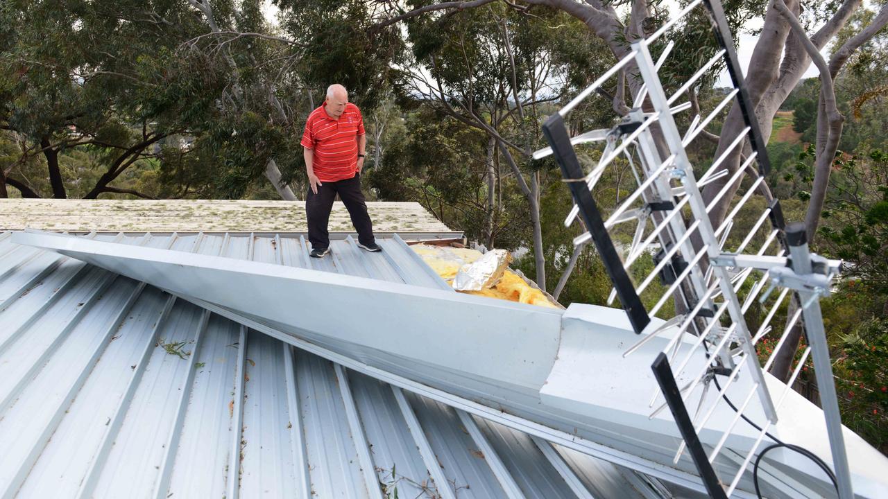 Mario Petruzzelli of Mitcham looks at his damaged roof. Picture: AAP / Brenton Edwards