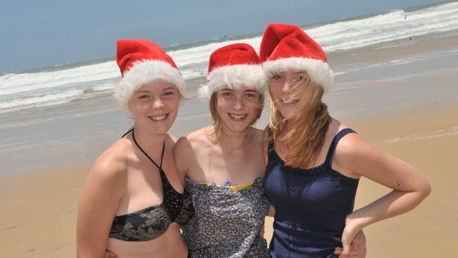 Christmas Day 2011 on the Sunshine Coast provided big seas, strong winds and blue skies but people were out in full voice to celebrate. Julie, Alice and Ida Listrup from Sweden on Coolum Beach.