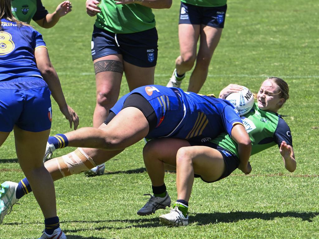 Reese Vidler is tackled by Taylah Falaniko. Picture: Martin Ollman