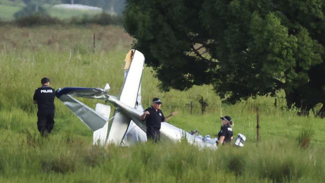 Police at the scene of the crash between a glider and ultralight. Picture: Lachie Millard