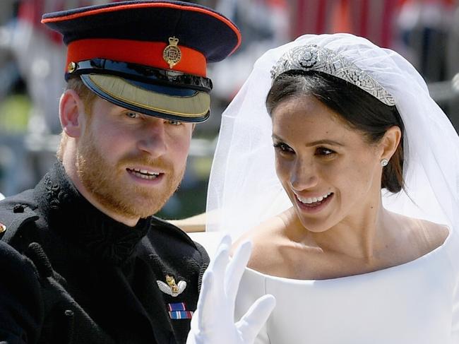 WINDSOR, ENGLAND - MAY 19:  (L-R) Prince Harry, Duke of Sussex and Meghan, Duchess of Sussex leave Windsor Castle in the Ascot Landau carriage during a procession after getting married at St Georges Chapel on May 19, 2018 in Windsor, England. Prince Henry Charles Albert David of Wales marries Ms. Meghan Markle in a service at St George's Chapel inside the grounds of Windsor Castle. Among the guests were 2200 members of the public, the royal family and Ms. Markle's Mother Doria Ragland.  (Photo by Jeff J Mitchell/Getty Images)