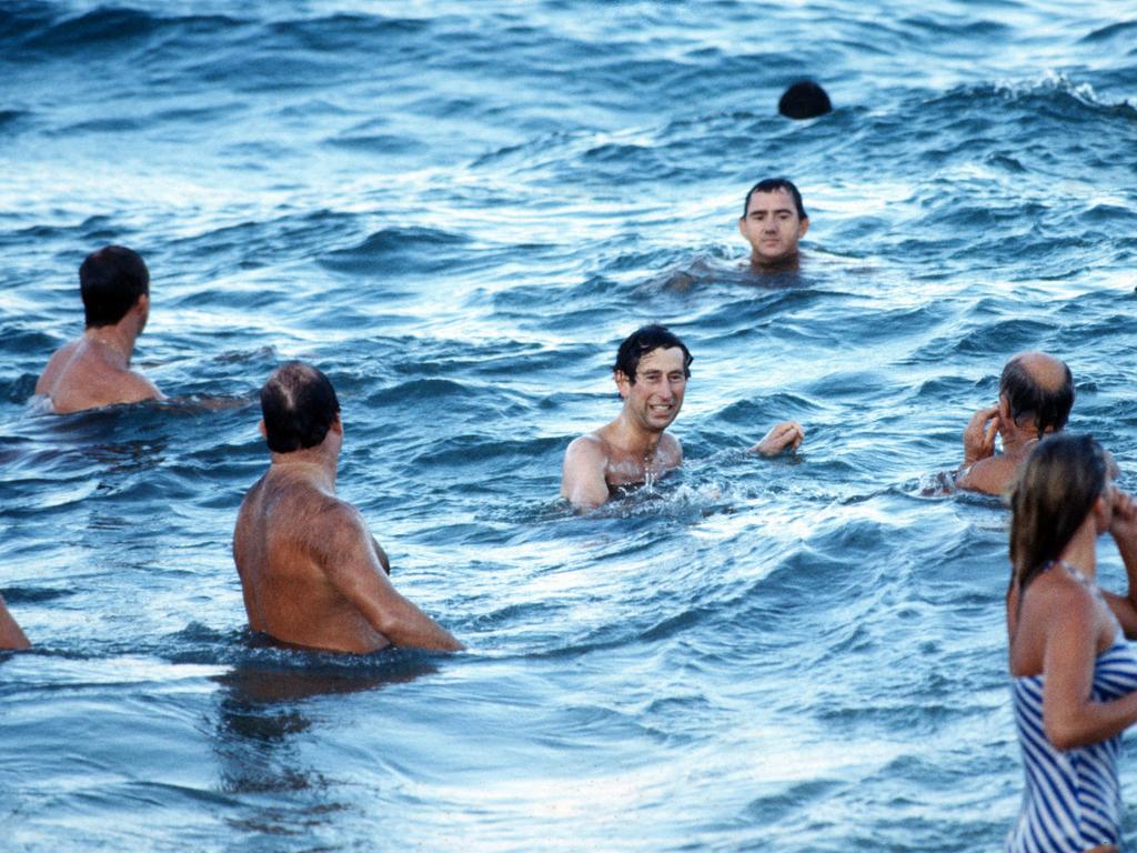 1981: Prince Charles enjoys a swim at Bondi surrounded by security. Picture: Anwar Hussein / Getty Images