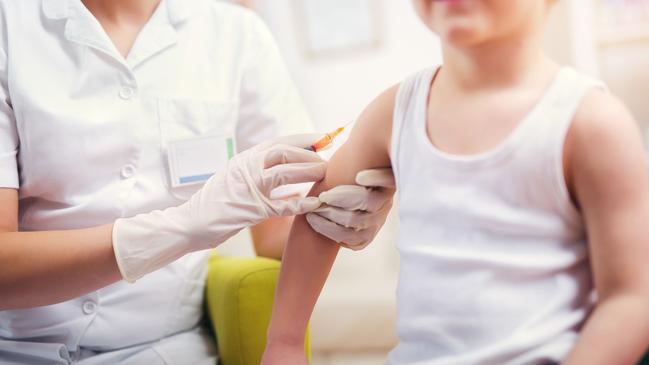 Pediatrician makes vaccination to small boy