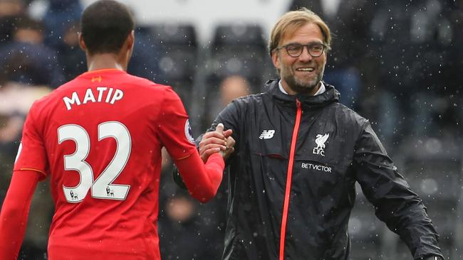 Liverpool’s Jurgen Klopp shakes hands with defender Joel Matip.
