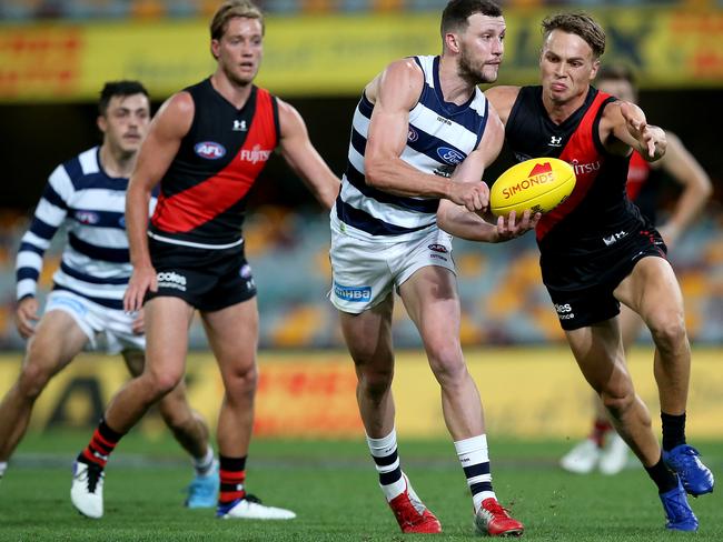 BRISBANE, AUSTRALIA - SEPTEMBER 06: Sam Menegola of the Cats makes a handpass during the round 16 AFL match between the Geelong Cats and the Essendon Bombers at The Gabba on September 06, 2020 in Brisbane, Australia. (Photo by Jono Searle/AFL Photos/via Getty Images)