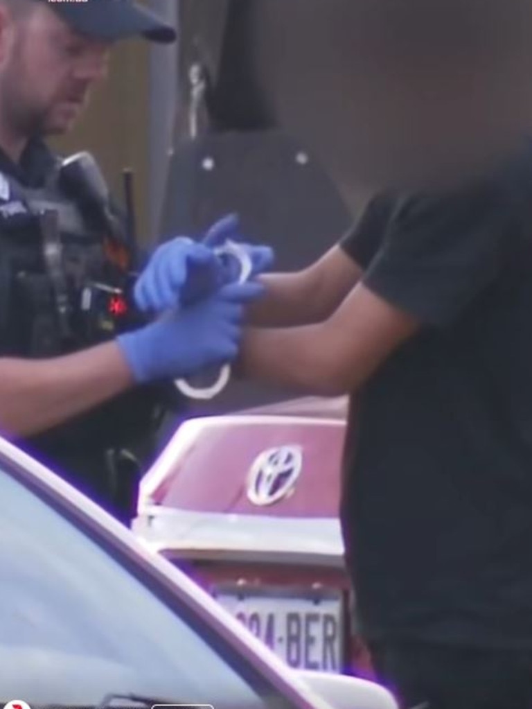 Police arrest one of the youths near the scene of the shooting at Andrews Farm. Picture: 7NEWS