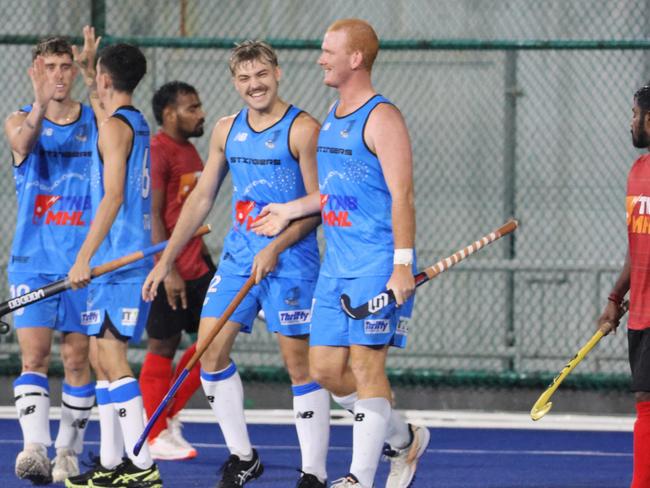 Luke Broadway (centre) celebrates a goal for the Territory Stingers. Picture: Hockey NT / Territory Stingers