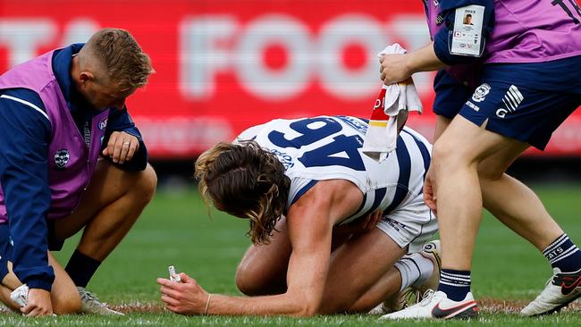 MELBOURNE - APRIL 10: Mark Blicavs of the Cats lays injured during the 2023 AFL Round 04 match between the Geelong Cats and the Hawthorn Hawks at the Melbourne Cricket Ground on April 10, 2023 in Melbourne, Australia. (Photo by Dylan Burns/AFL Photos via Getty Images)