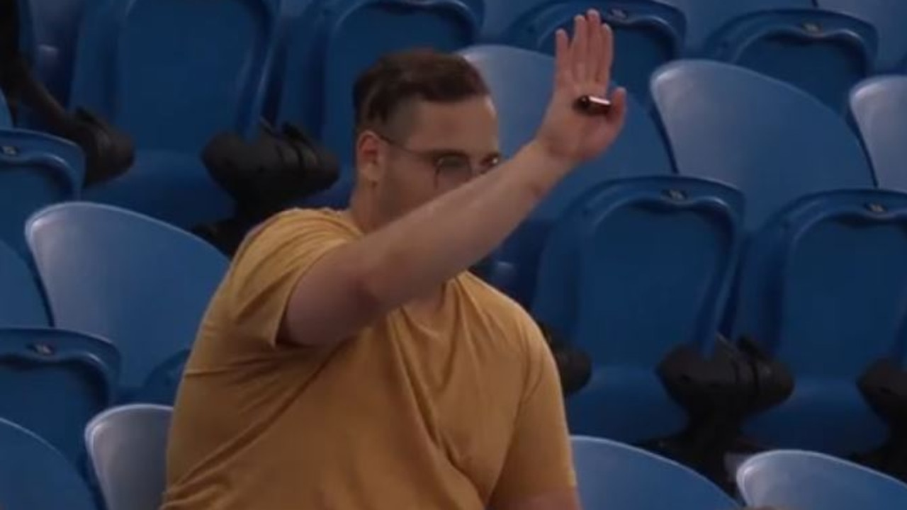 A member of the crowd signals to the umpire.