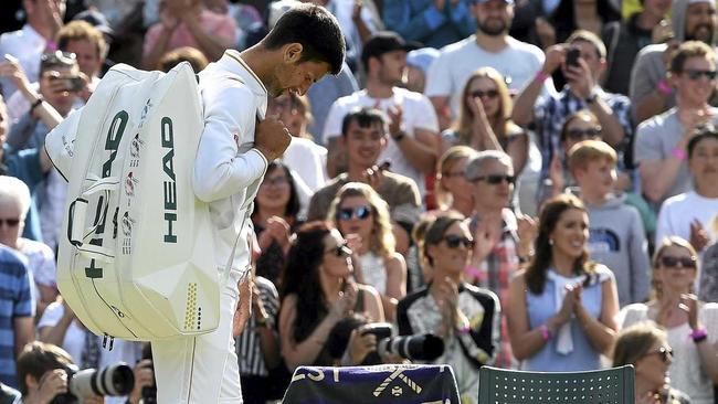 Novak Djokovic walks off court following his defeat by Sam Querrey. Picture: FACUNDO ARRIZABALAGA