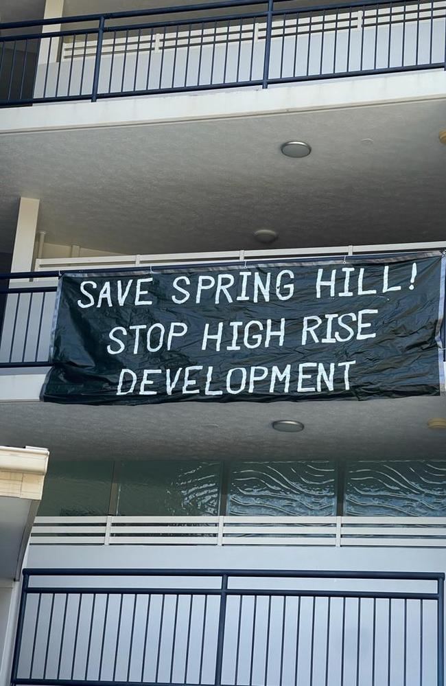 Protest signs on a nearby unit building which occupants say will now become a dark and airless canyon.