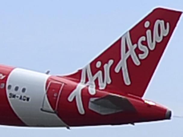 In this May 9, 2014 photo, an Air Asia A320-200 plane takes off from Kuala Lumpur International Airport 2 in Sepang, Malaysia. An AirAsia plane with 161 people on board lost contact with ground control on Sunday, Dec. 28, 2014, while flying over the Java Sea after taking off from a provincial city in Indonesia for Singapore, and search and rescue operations were underway. AirAsia, a regional low-cost carrier with presence in several Southeast Asian countries, said in a statement that the missing plane was an Airbus A320-200 and that search and rescue operations were in progress. The plane in this photo is the same model but not the one which went missing in Indonesia Sunday. (AP Photo/Joshua Paul)